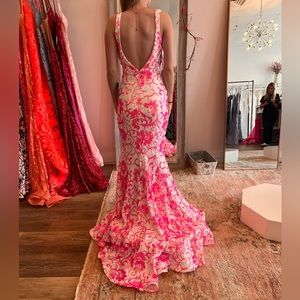 This dress was never worn, size two, pink and white with sequins.